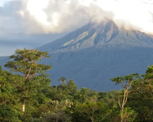 The Sumaco Volcano stands in the distance with Amazon lowland rainforest in the foreground