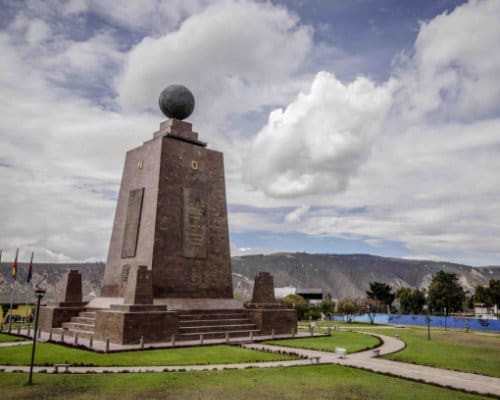 A tall monument dedicated to the measuring of the Equator holds a globe at the top of a four-sided tower.